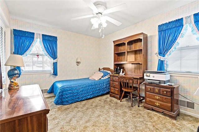 bedroom featuring wallpapered walls, ceiling fan, visible vents, and light colored carpet