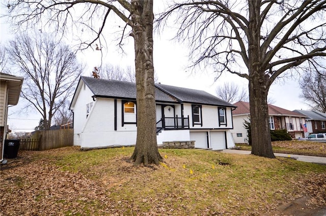 view of front of property featuring a garage and a front lawn