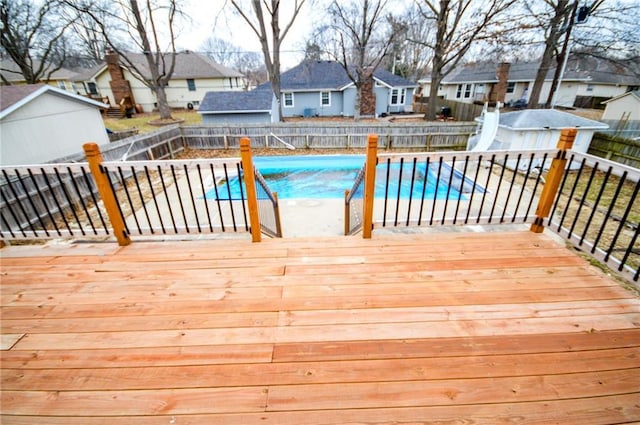 wooden deck featuring a fenced in pool