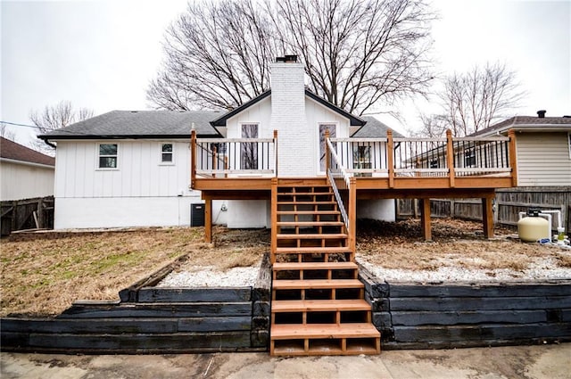 back of house featuring central air condition unit and a deck