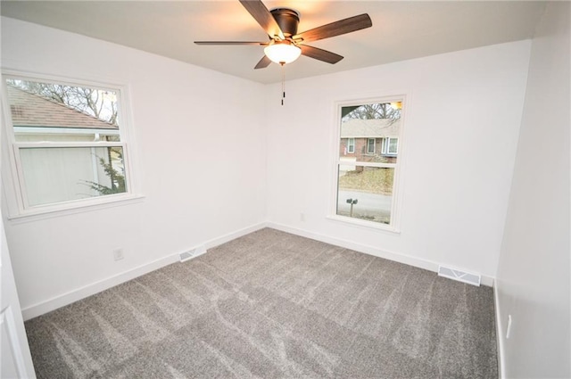 carpeted empty room featuring ceiling fan