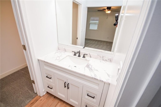 bathroom featuring vanity, wood-type flooring, and ceiling fan