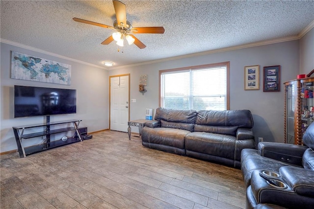 living area with ornamental molding, ceiling fan, a textured ceiling, and wood finished floors