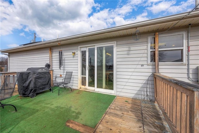 rear view of house with a yard and a wooden deck