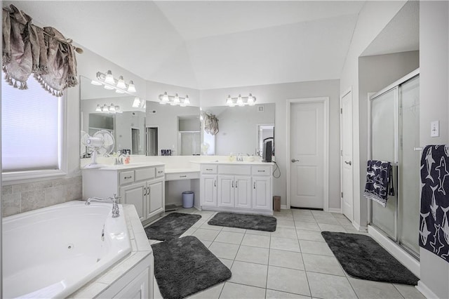 bathroom featuring vanity, vaulted ceiling, tile patterned floors, and separate shower and tub