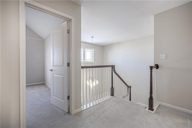 hall featuring light colored carpet