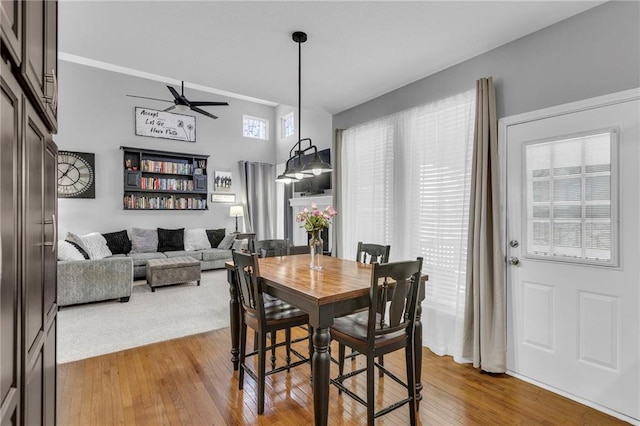 dining area featuring a ceiling fan and wood-type flooring