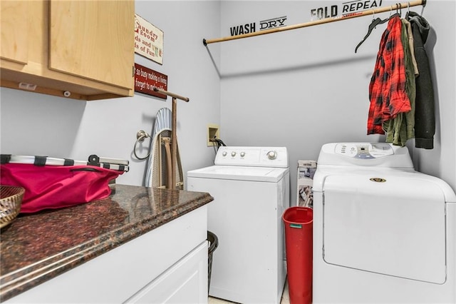 clothes washing area with cabinet space and separate washer and dryer