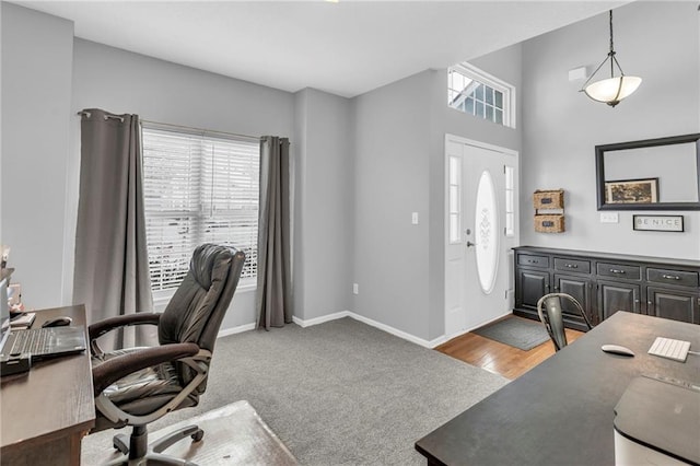 carpeted home office with baseboards