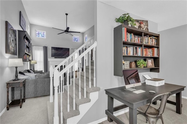 carpeted office featuring ceiling fan and baseboards