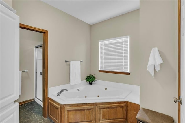 full bathroom with a whirlpool tub, a shower stall, and tile patterned floors