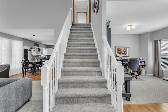 stairway featuring wood finished floors and baseboards