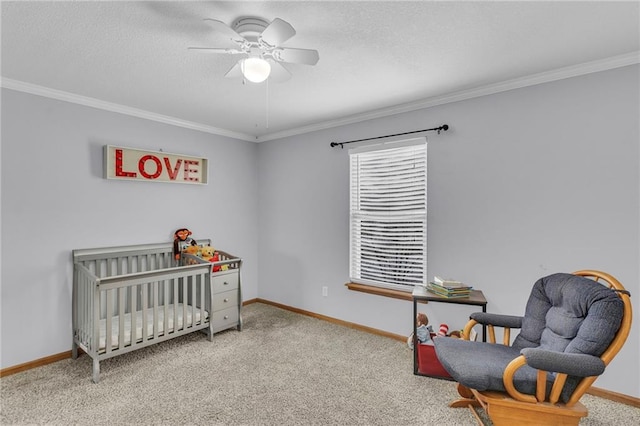 carpeted bedroom with crown molding, a textured ceiling, a nursery area, and baseboards