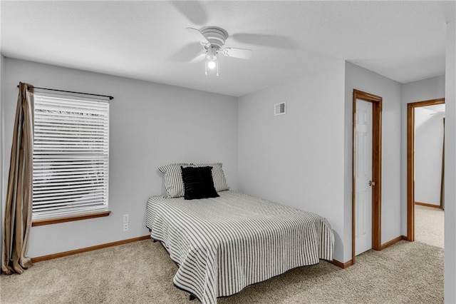 carpeted bedroom with visible vents, ceiling fan, and baseboards