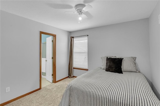 bedroom with ceiling fan, baseboards, connected bathroom, and light colored carpet