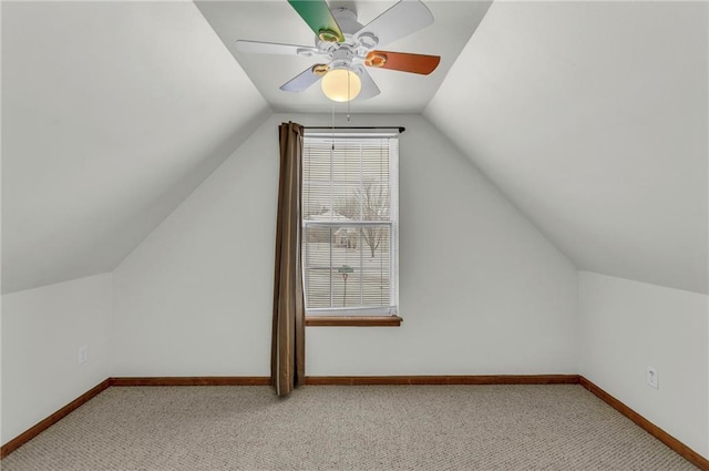 bonus room featuring baseboards, vaulted ceiling, and light colored carpet