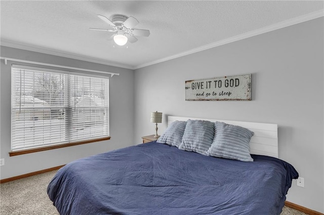 bedroom with carpet floors, ornamental molding, baseboards, and a ceiling fan