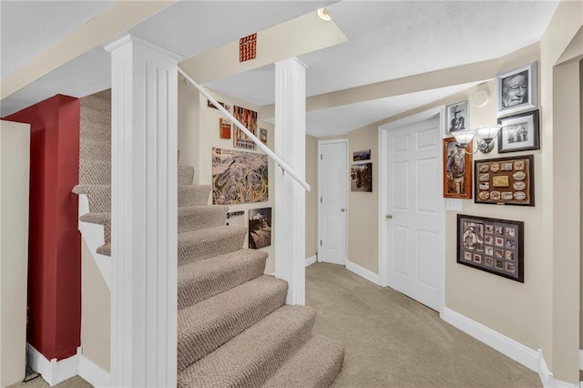 staircase with carpet floors and baseboards