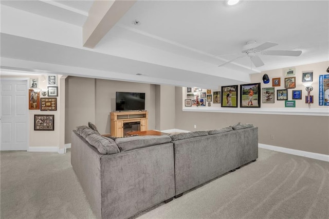 living room with carpet flooring, ceiling fan, beamed ceiling, and baseboards