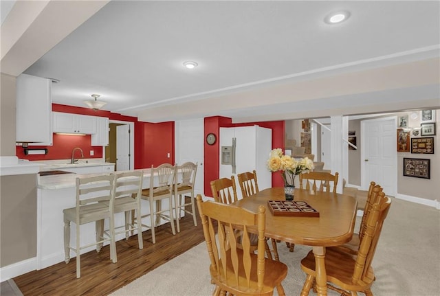 dining room with light wood-type flooring and baseboards