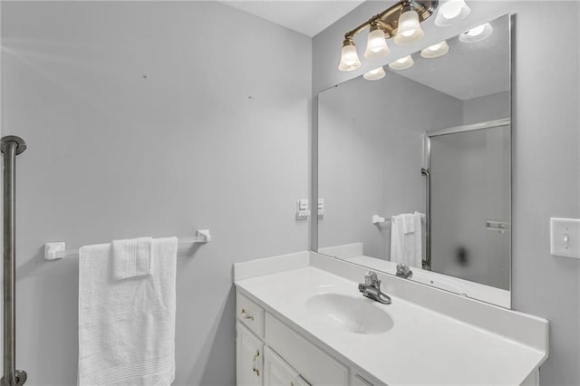 bathroom with vanity and a shower with shower door