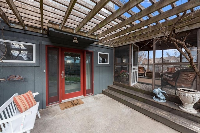 property entrance featuring a patio area and a pergola