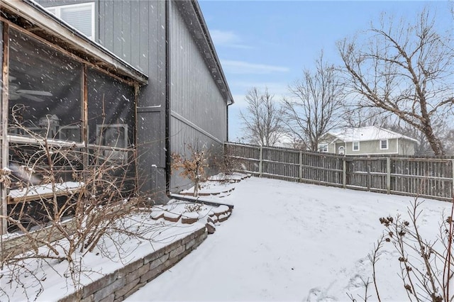 yard covered in snow featuring a fenced backyard