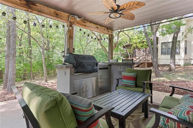 view of patio / terrace featuring grilling area, ceiling fan, and exterior kitchen