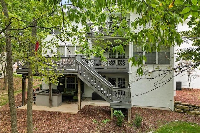 rear view of house featuring central AC unit, a patio area, and outdoor lounge area