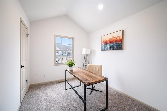 carpeted home office featuring lofted ceiling