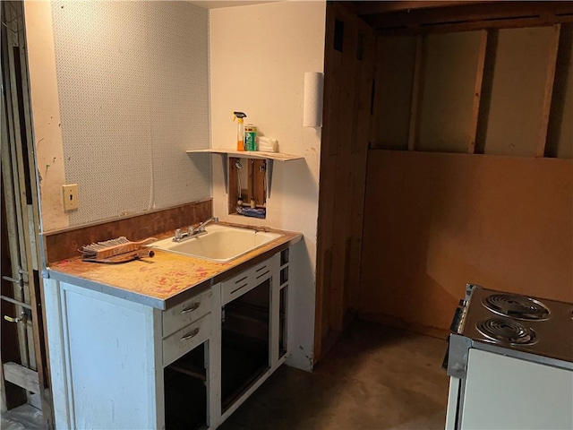 kitchen with light countertops, stainless steel range with electric cooktop, and a sink