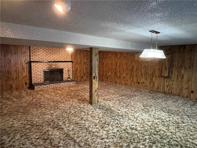 below grade area featuring carpet, a brick fireplace, and wooden walls