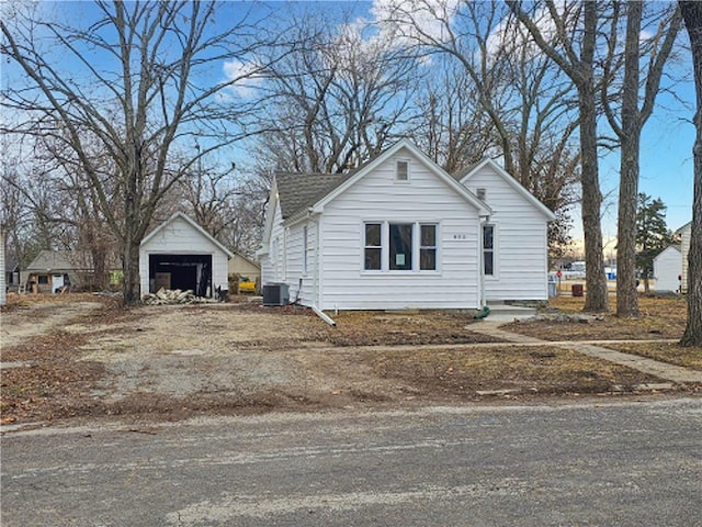 view of side of home featuring an outbuilding and a garage