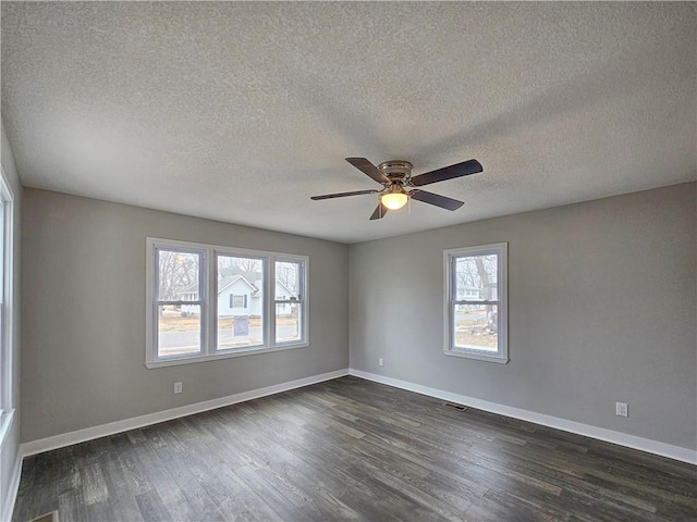 unfurnished room with a textured ceiling, dark hardwood / wood-style floors, and ceiling fan