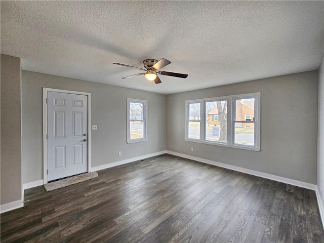 interior space featuring ceiling fan, a textured ceiling, and dark hardwood / wood-style flooring