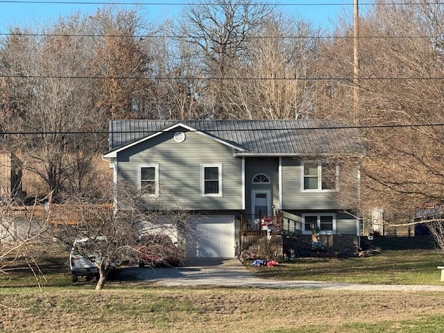 bi-level home featuring a garage and a front yard