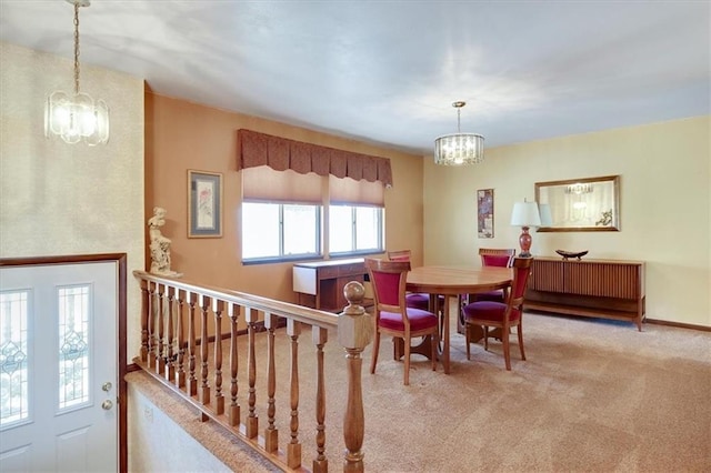 dining room featuring carpet floors, baseboards, and a notable chandelier