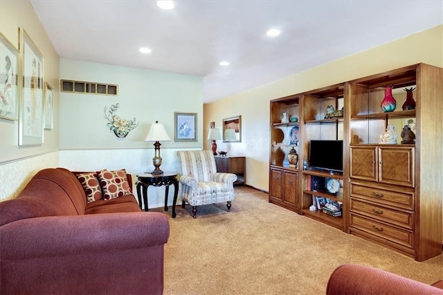 living area with carpet, visible vents, and recessed lighting