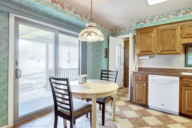 dining area with light floors and wallpapered walls