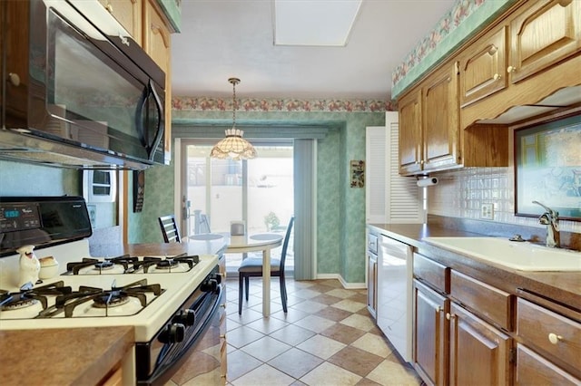 kitchen featuring white gas stove, a sink, black microwave, dishwashing machine, and wallpapered walls