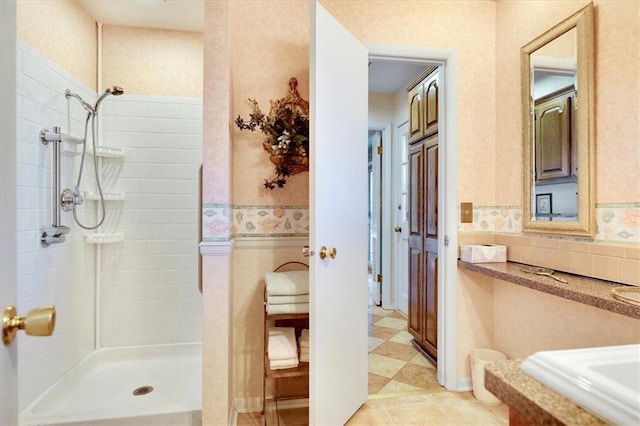 bathroom featuring tiled shower and backsplash