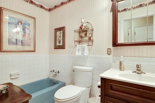 full bath featuring wallpapered walls, toilet, a wainscoted wall, vanity, and a bath