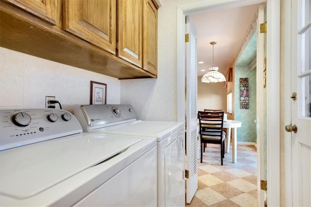 laundry room featuring cabinet space, light floors, and washing machine and clothes dryer