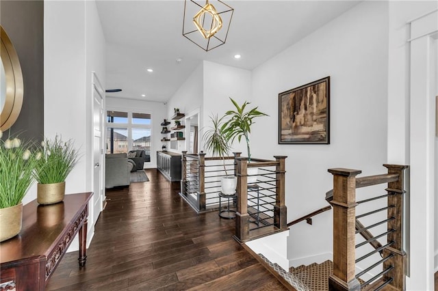 hall with dark wood-style floors, recessed lighting, baseboards, and an upstairs landing