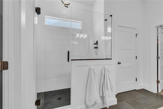 full bathroom with a shower stall and tile patterned floors