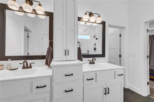 full bathroom with a stall shower, tile patterned floors, a sink, and double vanity