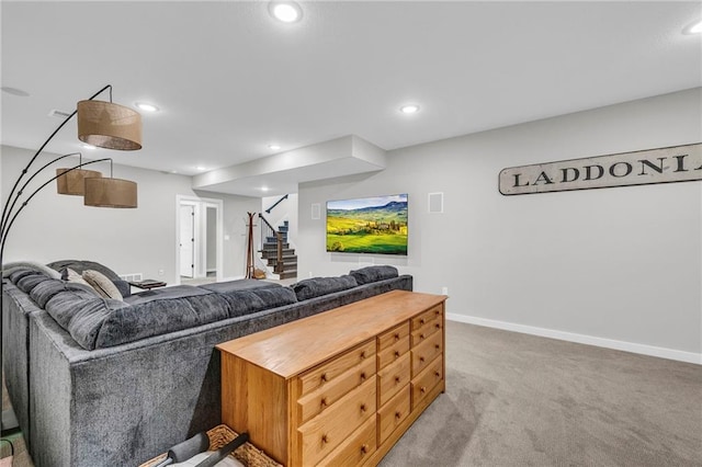 carpeted living room with stairs, baseboards, and recessed lighting