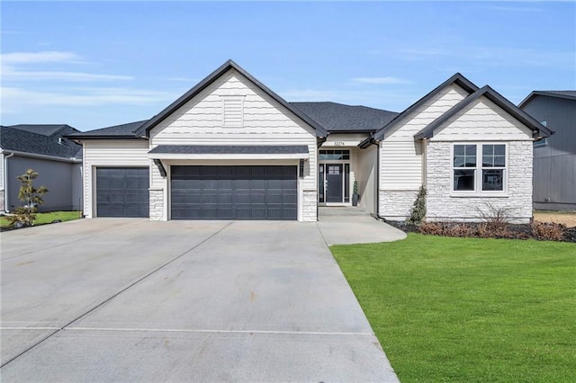 view of front of home with a garage, stone siding, driveway, and a front lawn