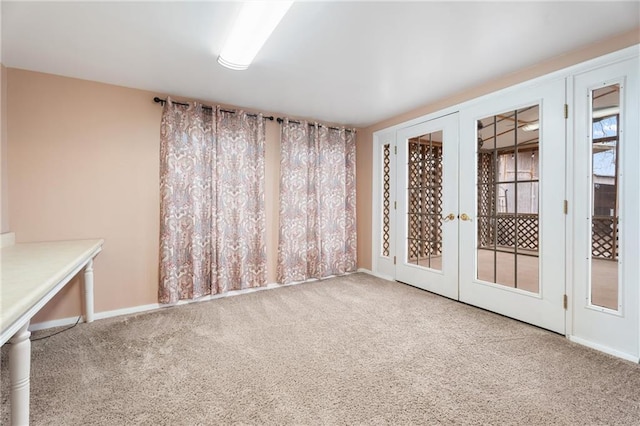 carpeted empty room featuring french doors