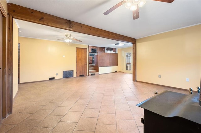 empty room with beamed ceiling, ceiling fan, and light tile patterned floors